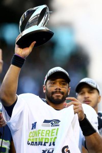 Russell Wilson with NFC Championship trophy
