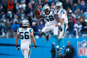 Thomas Davis celebrates with Cam Newton after Davis recovered Seattle on-side kick